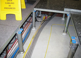 TT1000 water sensing cable clipped to the slab within a raised floor.