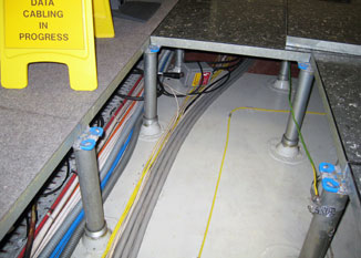 TT1000 water sensing cable clipped to the slab within a raised floor.
