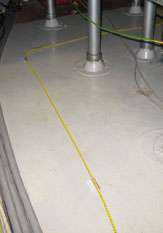 TT1000 water sensing cable clipped to the floor below a tea point or breakout area